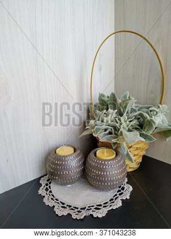 Plant Woolly Stachys With Soft Fluffy Leaves In A Wicker Basket With Two Shaffron Candles On A Light