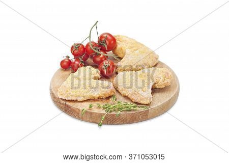 Raw Crispy Chicken Wings Breaded In Bread Crumbs On A Wooden Board With Cherry Tomato And Thyme. Rea
