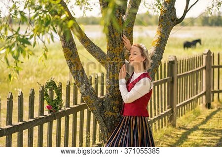 Latvian Woman In Traditional Clothing. Ligo Folk.