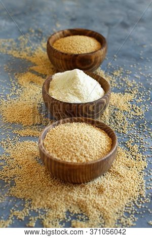 Bowl Of Raw Amaranth Flour And Seeds  On A Grey Table Close Up
