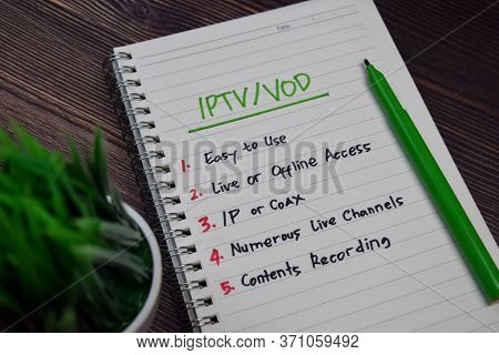 Iptv/vod Write On A Book With Keywords Isolated Wooden Table.