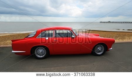 Felixstowe, Suffolk, England - May 05, 2019: Classic Red Peerless 
 Gt Motor Car Parked On Seafront 