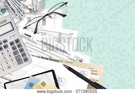 Irs Form 1040nr Nonresident Alien Income Tax Return Lies On Flat Lay Office Table And Ready To Fill.