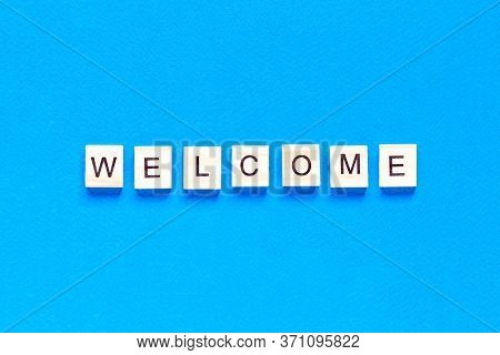 Welcome Sign In Wooden Letters On A Blue Background. Business Concept, Sales, Stores, Gifts. Top Vie