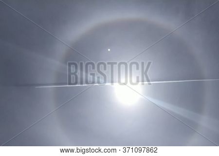 The Phenomenon Of Halo In The Sky. A Rare Natural Phenomenon. Three Halo Suns. The Plane Flies Throu