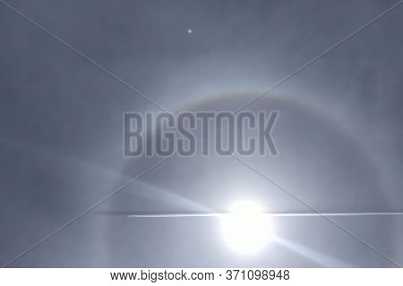 The Phenomenon Of Halo In The Sky. A Rare Natural Phenomenon. Three Halo Suns. The Plane Flies Throu