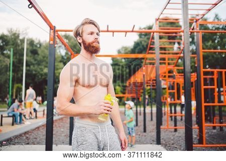 Sporty Muscular Man Drinking Water In Gym. Thirsty And Dehydration From Workout And Losing Too Much 