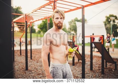 Sporty Muscular Man Drinking Water In Gym. Thirsty And Dehydration From Workout And Losing Too Much 