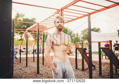Sporty Muscular Man Drinking Water In Gym. Thirsty And Dehydration From Workout And Losing Too Much 