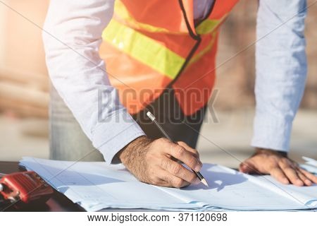 Close Up Engineer Checking Blueprint Of Building.