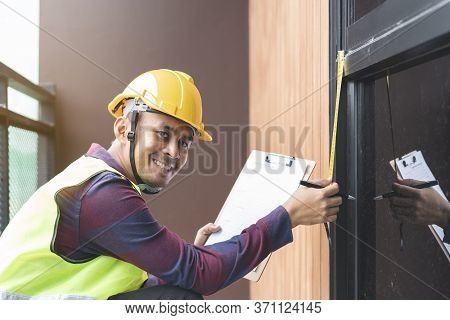 Home Inspection Consultancy. Inspector Checking Window Installation And Sliding Window To Test.