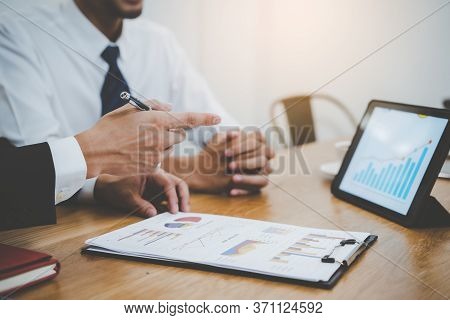 Financial Advisory Services. Asian Advisor Showing Plan Of Investment To Clients In The Consultancy 