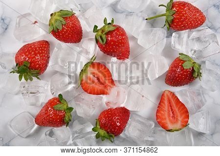 Close Up Fresh Red Ripe Strawberries And Ice Cubes On Table, El;evated High Angle View, Directly Abo
