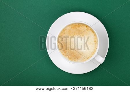 Close Up One Full White Cup Of Frothy Latte Cappuccino Coffee On Saucer On Green Table Background, E