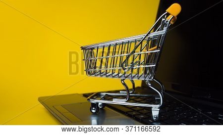 E-commerce, Concept. Online Shopping, Shopping Cart On Laptop Keyboard. Shopping In Online Stores An