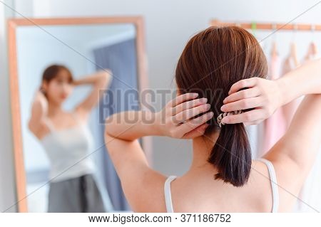 Asian Woman Make Up And Dress-up At Home. Lifestyle In The Bedroom. Social Distancing And Self-quara