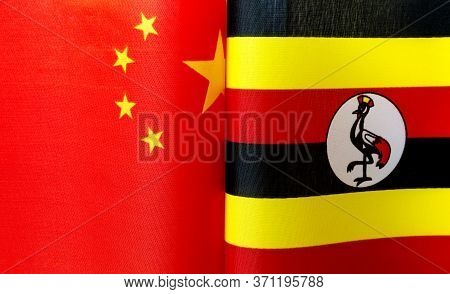 Fragments Of The National Flags Of China And The Republic Of Uganda Close Up