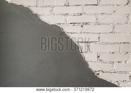 The Brick Wall Is Half Covered With Plaster. Surface Treatment And Decoration Techniques