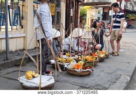 Hoi An, Vietnam - March 20, 2016: Street Vietnames Vendors With Exotic Fruits