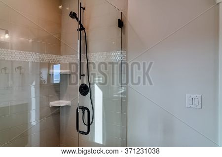 Shower Stall With Frameless Glass Enclosure And Hinged Door Inside Bathroom