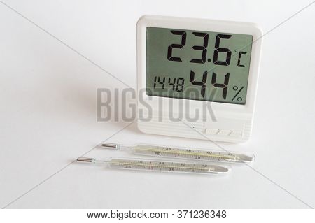 Two Digital Mercury Thermometers And A Household White Thermometer