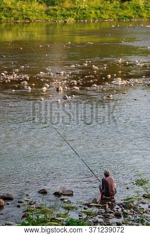 Fisherman Fishing On A Fishing Rod In A River