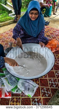 Cooking Traditional Malaysian Sweet Desert, Dodol By The Villagers During Hari Raya.