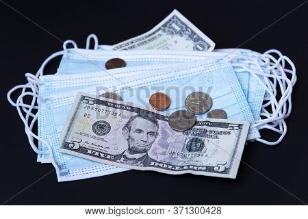 Medical Face Mask And Money On A Black Background. World Coronavirus Epidemic And Economic Losses Co