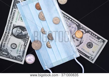 Medical Face Mask And Money On A Black Background. World Coronavirus Epidemic And Economic Losses Co