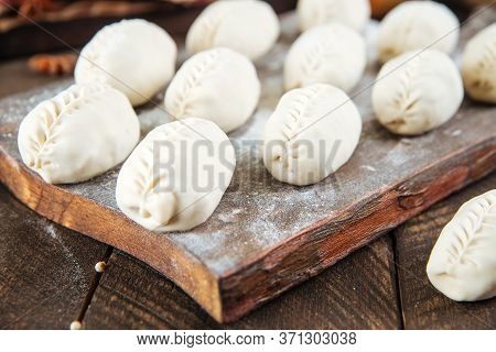 Closeup On Semi-finished Manti Dumplings On The Wooden Board, Horizontal