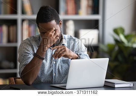 African Guy Rubbing Dry Eyes Takes Off Spectacles Relieving Eyestrain