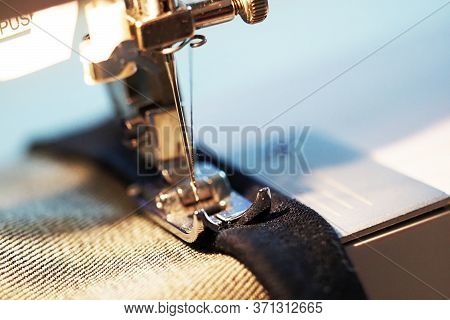 Sewing Machine. Tailor Working, Hem The Dark Blue Jeans, Macro