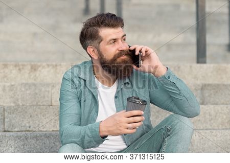 Holding Conversation Over Cup Of Coffee. Bearded Man Have Phone Conversation. Answering Conversation