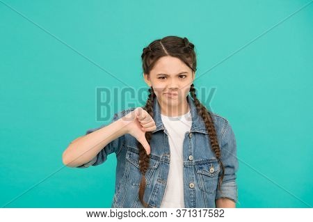 Turning Thumbs Down. Unhappy Child Give Thumbs Down Blue Background. Gesturing Thumbs Down. Thumbs D