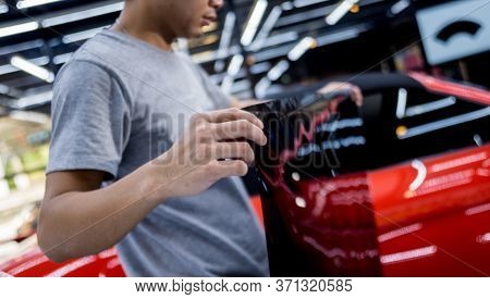 Applying Tinting Foil On A Car Window In A Auto Service