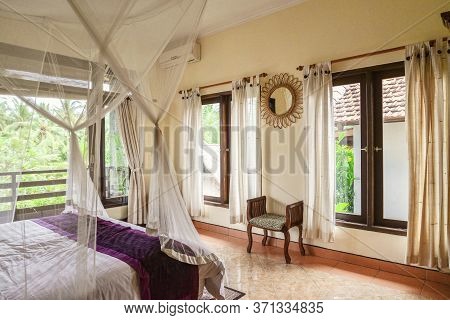Cozy Canopy Bed In Bedroom With Balcony