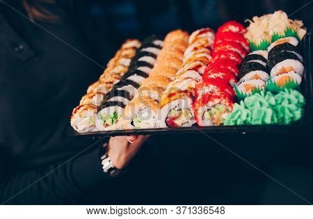 Close-up Hand Waiter Holding Set Delicious Fresh Sushi Slate Plate Sushi Rolls Warm Ebi Sake Unagi,