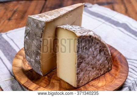 Pieces Of Cheese Tomme De Montagne Or Tomme De Savoie Made From Cow Milk In French Alps.