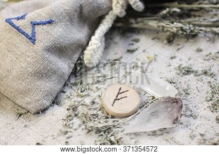Scandinavian Wooden Rune Fehu, Fe, Feoh On A Rough Linen Cloth With Amethyst Crystalline, Rock Cryst