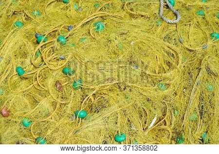 Yellow Fishing Net With Green Floats, Background.