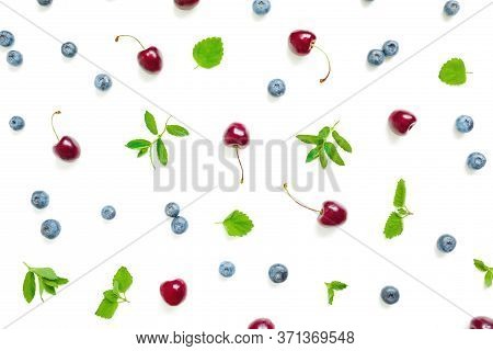 Swet Cherry And Blueberries With Mint Leaves On White Background. Top View. Flat Lay Summer Pattern