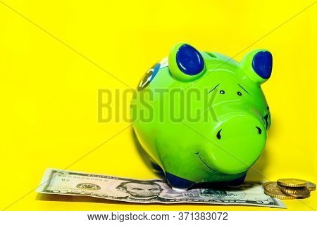 Piggy Money Box, Banknotes And Coins On Yellow Background, Close-up, With A Copy Of The Space.