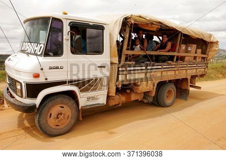 Itamaraju, Bahia Brazil - September 23, 2010: People Are Seen In A Truck Body On A Dirt Road In The 