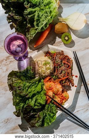 Korean Beef Bulgogi Ssambap Lettuce Wraps With Spicy Kimchi And Gochujang Hot Sauce