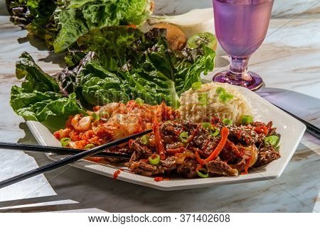 Korean Beef Bulgogi Ssambap Lettuce Wraps With Spicy Kimchi And Gochujang Hot Sauce