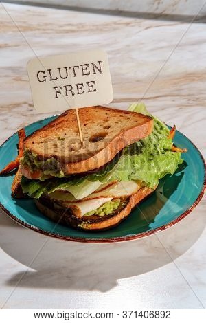 Deli Chicken Guacamole Sandwich On Gluten-free Sliced Bread With Sweet Potato Fries
