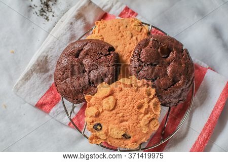 Oatmeal Cookie Milk Cookie And Chocolate Chip Nut Cookie On Grate Metal Red And White Napkin Black B