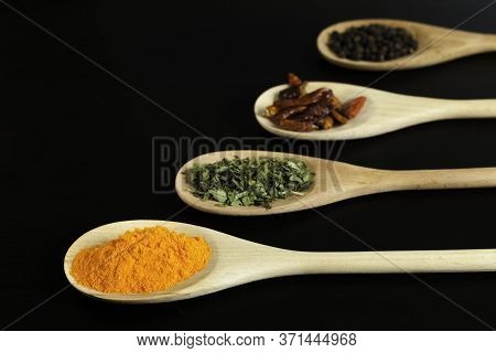 Spices In Wooden Spoons