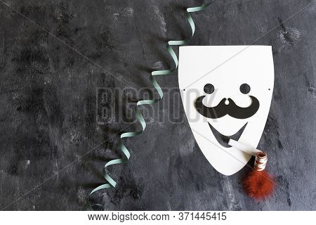 Paperboard Mask With Serpentine And Matasuegras On Dark Background