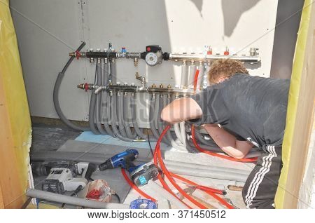 Kyiv, Ukraine - June, 23, 2020:  A Building Contractor Is Installing Energy Efficient Hydronic Hot W